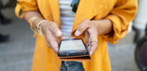 Close-up of woman using mobile phone at outdoor market